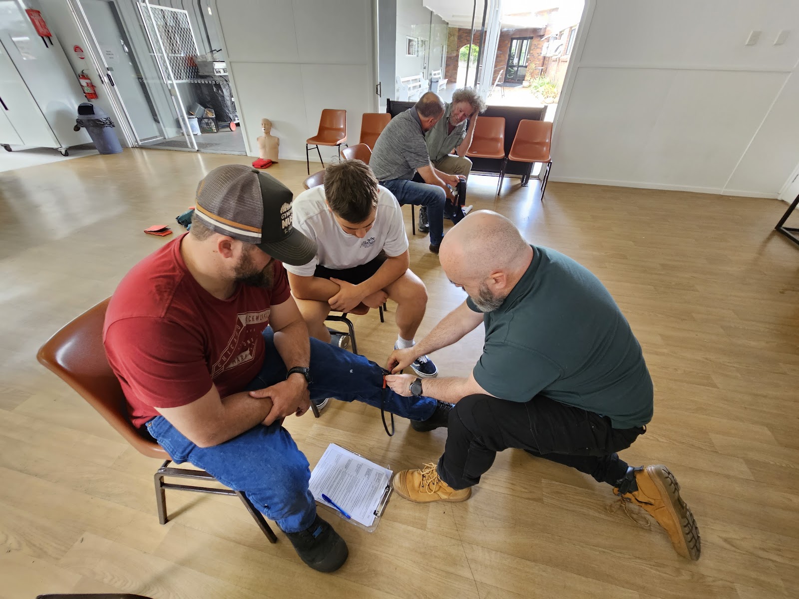Chermside Remote first aid participants learning snake bite bandaging.